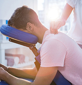 Physiotherapist treating a patient's shoulder at the clinic